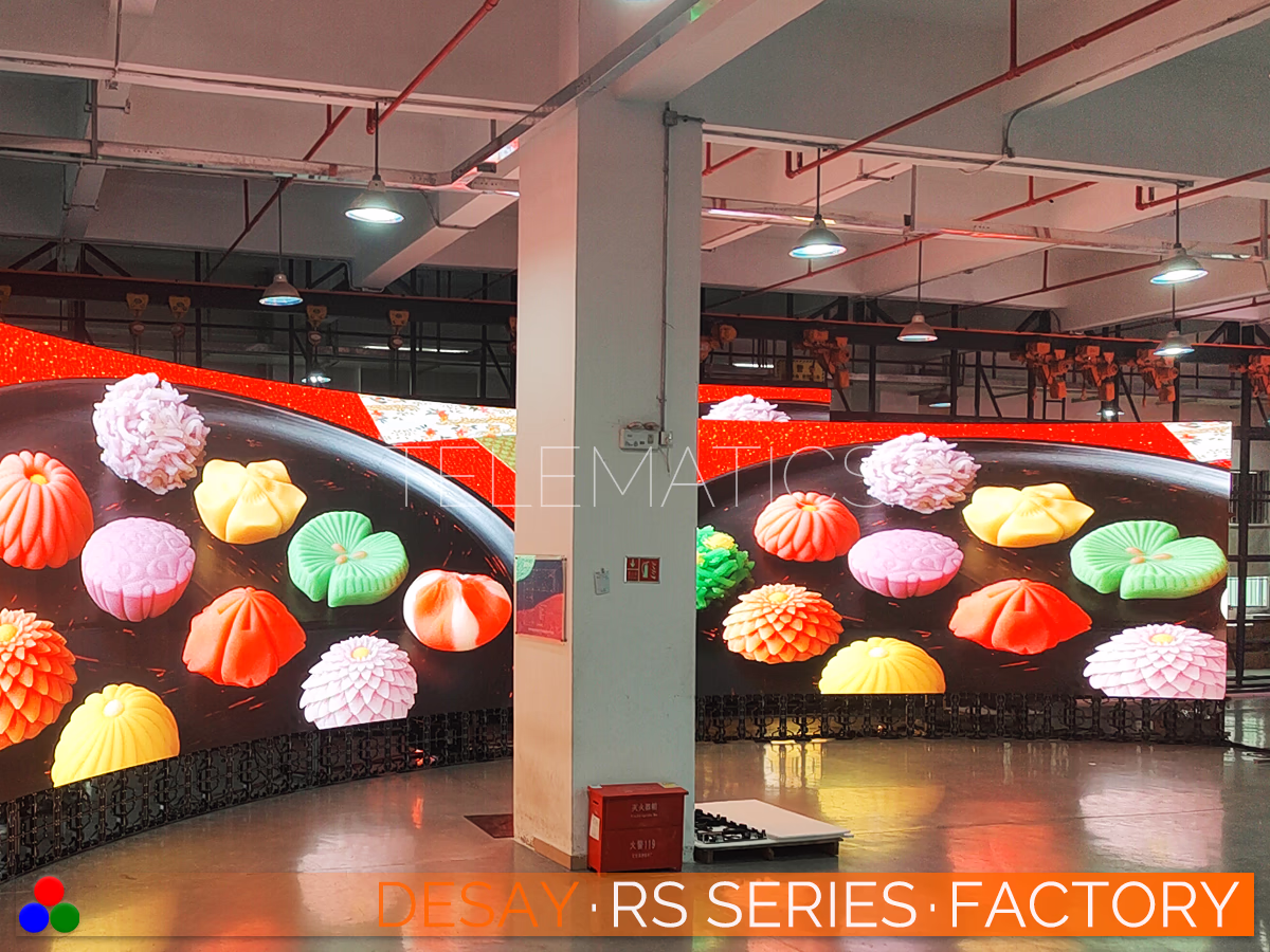 The Art Of LED · Desay RS Series · Telematics Canada Color fidelity testing on a curved LED screen using vibrant high-resolution food imagery to ensure accurate red and green spectrum rendering for broadcast standards.