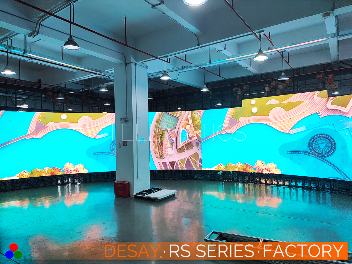 The Art Of LED · Desay RS Series · Telematics Canada Factory floor view of a Desay RS Series curved wall, demonstrating the smooth screen surface and precise module alignment required for seamless panoramic viewing.