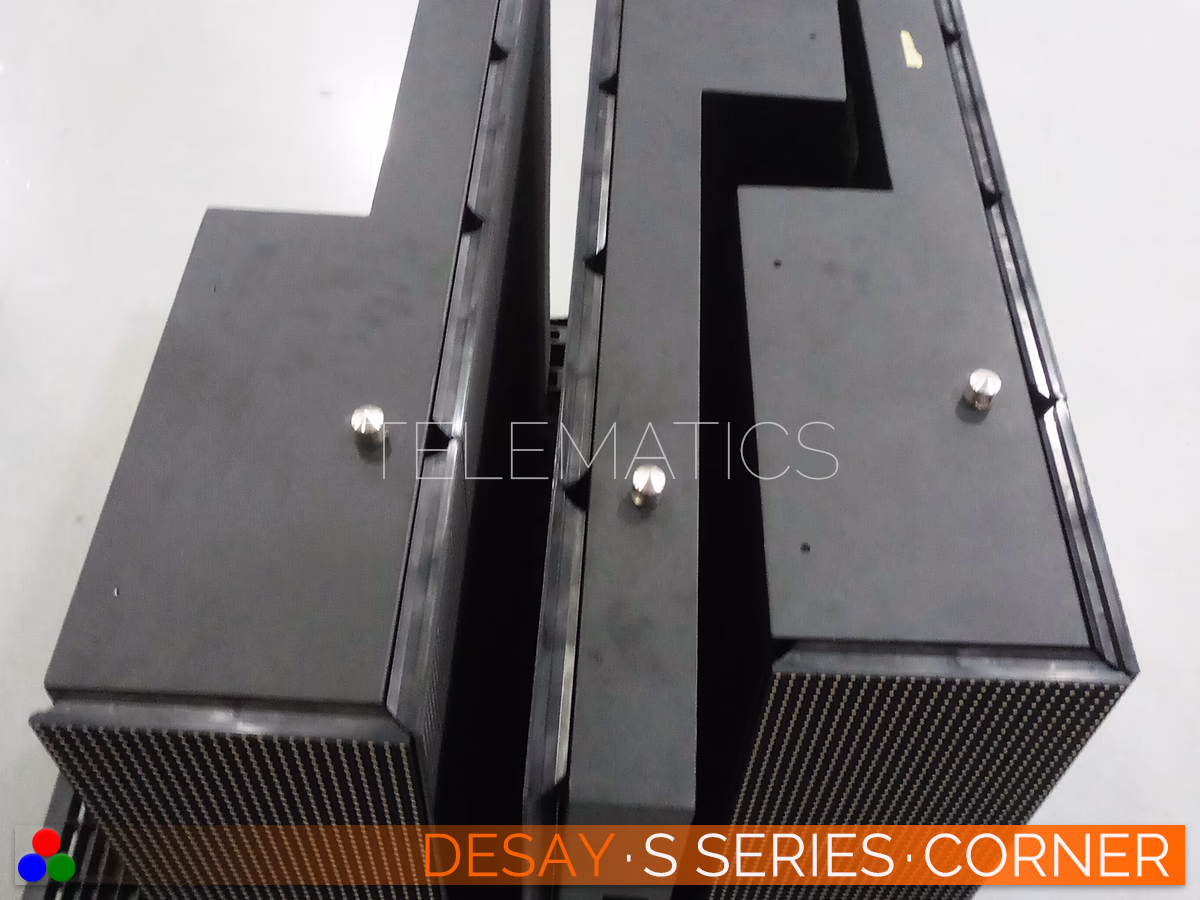 The Art Of LED · Desay S Series · Telematics Canada Desay S Series outdoor LED cabinet top view showing the custom beveled edge design and steel alignment pins for seamless 90-degree corner splicing.