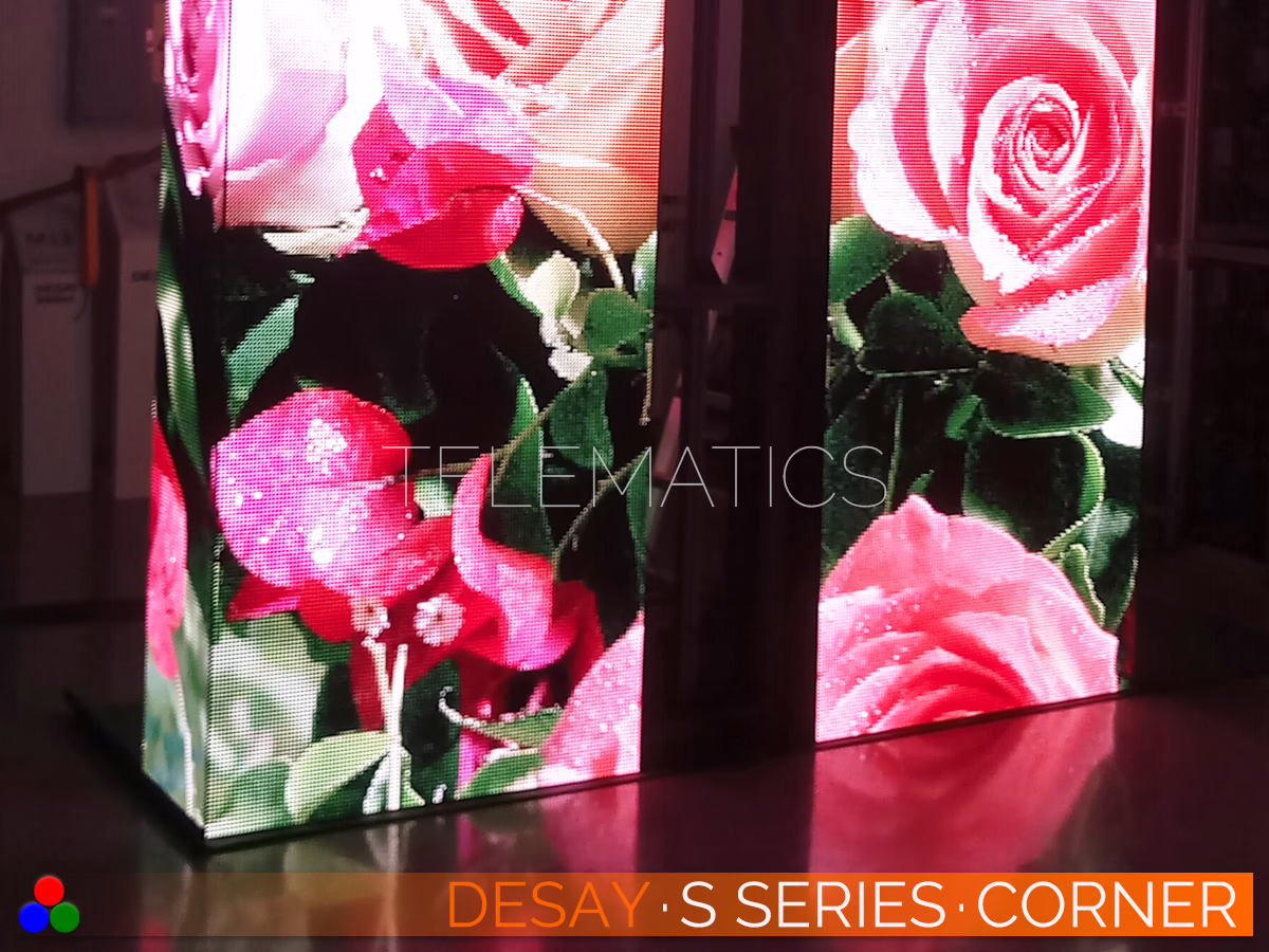 The Art Of LED · Desay S Series · Telematics Canada Desay S Series outdoor LED pillars featuring seamless corner splicing and vivid color reproduction of floral imagery in a retail environment.