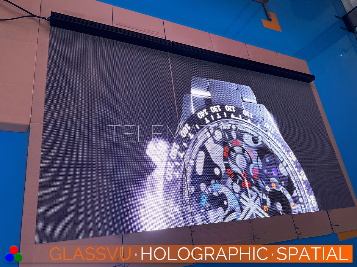 The Art Of Light · GlassVu Spatial · Telematics Canada Large format GlassVu 3D holographic LED matrix undergoing factory visual calibration with bright commercial graphics.